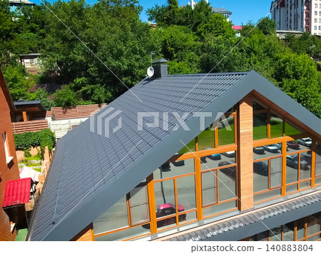 Corrugated metal roof and metal roofing. Modern roof made of metal. Corrugated metal roof and metal roofing. Modern roof made of metal. 140883804