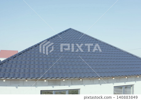 Corrugated metal roof and metal roofing. Modern roof made of metal. Corrugated metal roof and metal roofing. Modern roof made of metal. 140883849