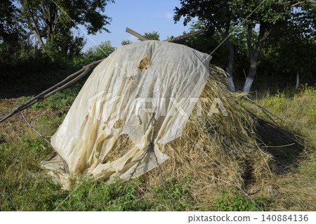 Haystack. A haystack of grass hay. Hay making. Haystack. A haystack of grass hay. Hay making. 140884136