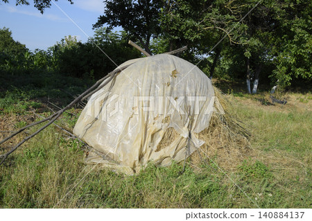 Haystack. A haystack of grass hay. Hay making. Haystack. A haystack of grass hay. Hay making. 140884137