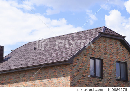 The house with plastic windows and a roof of corrugated sheet The house with plastic windows and a roof of corrugated sheet 140884376