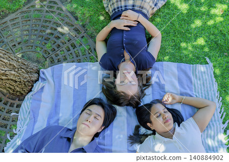 International group of university students lying on the grass International group of university students lying on the grass 140884902