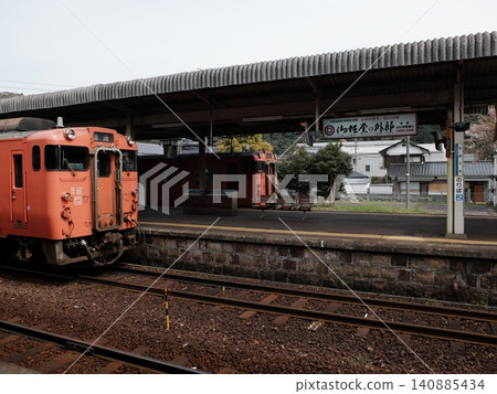 A KiHa 40 series diesel railcar stopped at the platform of Yamaguchi Station. A KiHa 40 series diesel railcar stopped at the platform of Yamaguchi Station. 140885434