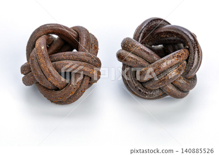Two handcrafted leather Turk's Head woggles, traditional Thai scout neckerchief slides, woven braided rope knot design in rich brown tones, isolated on a clean bright white studio background close up Two handcrafted leather Turk's Head woggles, traditional Thai scout neckerchief slides, woven braided rope knot design in rich brown tones, isolated on a clean bright white studio background close up 140885526