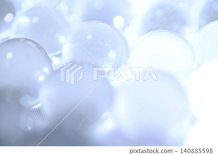 A bright, sparkling blue glass bead. A bright, sparkling blue glass bead. 140885598