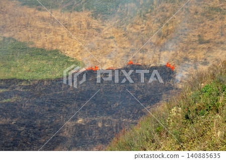 The flames spread across Mount Kanpu as it is burned. The flames spread across Mount Kanpu as it is burned. 140885635