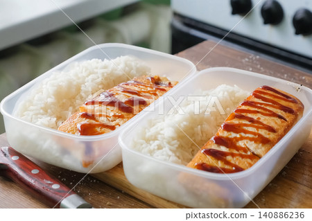 Rice porridge and fried fish in plastic container. Rice porridge and fried fish in plastic container. 140886236