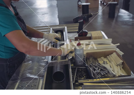 Worker works at a climatic equipment factory. Worker works at a climatic equipment factory. 140886254