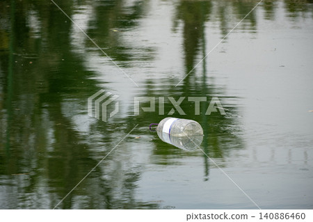 Marine Plastic Pollution with Discarded Bottle. 140886460