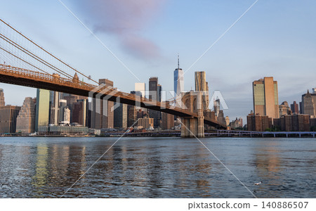 Urban architecture of New York city view. Brooklyn bridge of New York city. Brooklyn landmark. Manhattan cityscape with skyscraper architecture. Brooklyn bridge to Manhattan 140886507