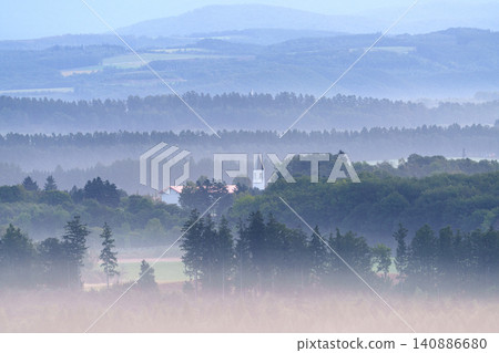 An autumn early morning in Biei, Hokkaido: A fantastical rural landscape of rolling hills enveloped in morning mist. An autumn early morning in Biei, Hokkaido: A fantastical rural landscape of rolling hills enveloped in morning mist. 140886680