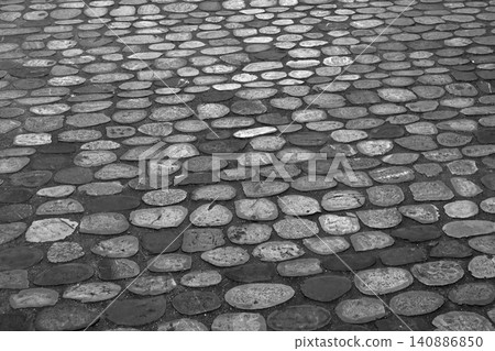 Textured Cobblestone Surface in Black and White Ideal for Backgrounds and Design Projects Textured Cobblestone Surface in Black and White Ideal for Backgrounds and Design Projects 140886850