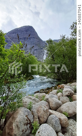Kleivafossen is one of Norway's most iconic waterfalls, on the way to the Briksdalsbreen glacier Kleivafossen is one of Norway's most iconic waterfalls, on the way to the Briksdalsbreen glacier 140887041