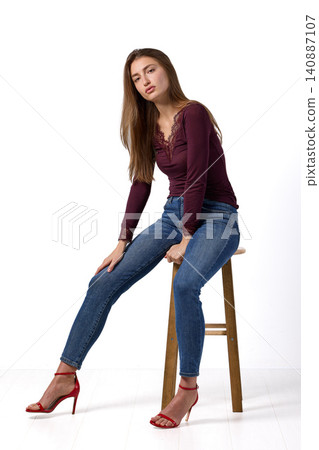 Slavic fashion model seated in studio portrait Slavic fashion model seated in studio portrait 140887107