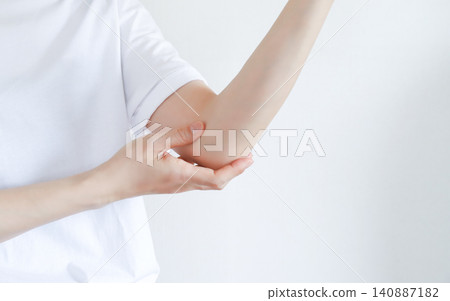 A woman who is concerned about elbow pain A woman who is concerned about elbow pain 140887182