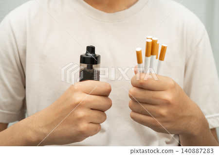Man holding electronic cigarettes, no smoking. Man holding electronic cigarettes, no smoking. 140887283