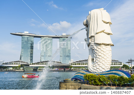 Low-angle view of the Merlion with the background of Marina Bay Sands buildings in Singapore. Merlion is the official mascot of Singapore. 140887407