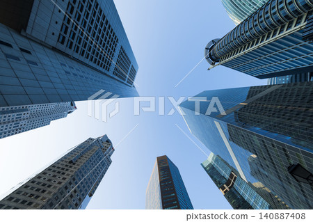 Low-angle building view of the modern office skyscrapers in the financial district of Raffles Place, Singapore. Low-angle building view of the modern office skyscrapers in the financial district of Raffles Place, Singapore. 140887408