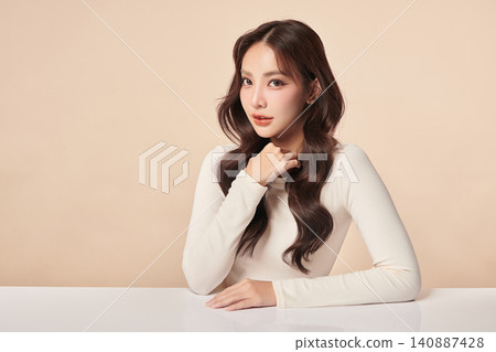 A beautiful young Asian woman with clean, fresh skin against a beige background. Skincare, facial treatment, cosmetology, beauty, and spa. An elegant portrait of an Asian woman. A beautiful young Asian woman with clean, fresh skin against a beige background. Skincare, facial treatment, cosmetology, beauty, and spa. An elegant portrait of an Asian woman. 140887428