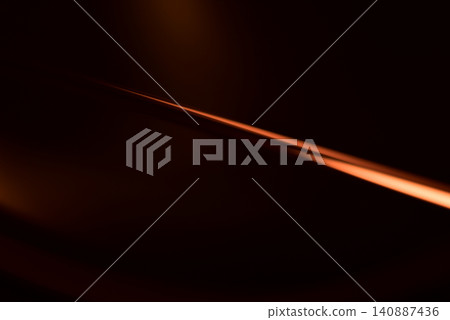 Abstract background material with brown light ray patterns on a dark background; line background. Abstract background material with brown light ray patterns on a dark background; line background. 140887436