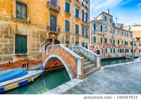 Amazing cityscape of Venice with narrow canals, boats and gondolas and bridges with traditional buildings. Amazing cityscape of Venice with narrow canals, boats and gondolas and bridges with traditional buildings. 140887633