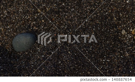 Sand and stones on the beach 140887654