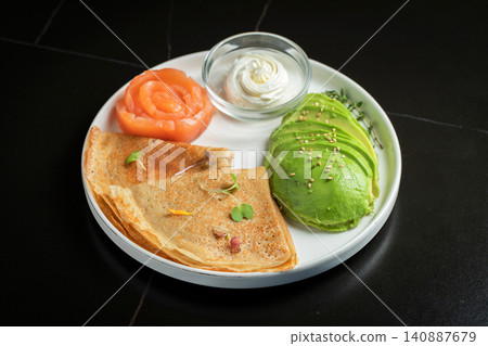 Roasted thin pancakes with smoked salmon and sauce Roasted thin pancakes with smoked salmon and sauce 140887679