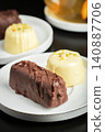 Delicious glazed curd snacks with fresh blueberries and mint on light grey table, closeup 140887706
