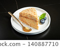 Medovik. Honey cake made from honey cakes with whipped sour cream, decorated with berries, pomegranate and flowers 140887710