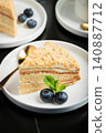 Medovik. Honey cake made from honey cakes with whipped sour cream, decorated with berries, pomegranate and flowers 140887712