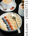 Oatmeal. Bowl of oatmeal porridge with blackberry, bananas and chia seeds on gray concrete old table background. Top view in flat lay style. Natural ingredients. Hot healthy breakfast and diet food 140887713