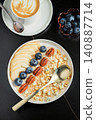 Oatmeal. Bowl of oatmeal porridge with blackberry, bananas and chia seeds on gray concrete old table background. Top view in flat lay style. Natural ingredients. Hot healthy breakfast and diet food 140887714