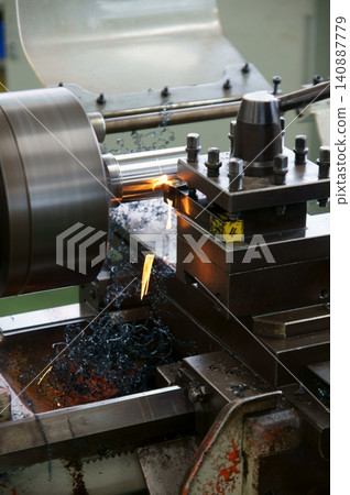 The process of cutting metal on a lathe. The process of cutting metal on a lathe. 140887779