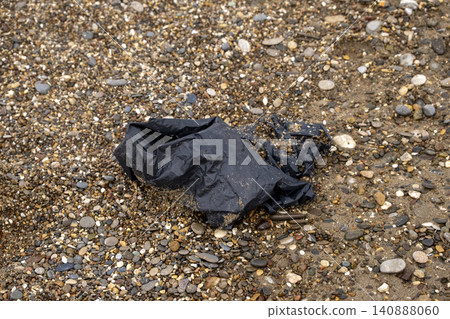 Plastic Bag Litter on a Sandy Beach. 140888060