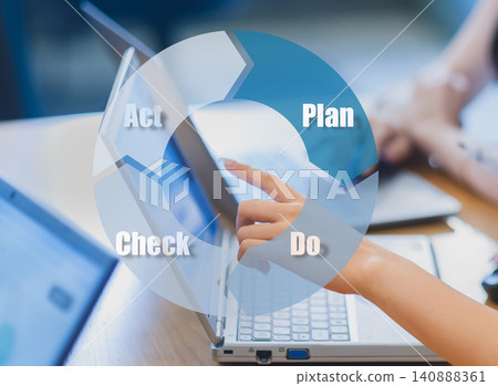 A woman's fingertip points to a laptop monitor; an image representing the PDCA cycle and business improvement; a meeting scene. A woman's fingertip points to a laptop monitor; an image representing the PDCA cycle and business improvement; a meeting scene. 140888361