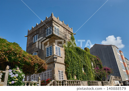 The historic Pazo de Fajardo displays its imposing crenellated stone tower against the sky of Cambados, Galicia. 140888579