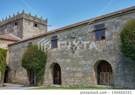 The historic Pazo de Fajardo displays its imposing crenellated stone tower against the sky of Cambados, Galicia. The historic Pazo de Fajardo displays its imposing crenellated stone tower against the sky of Cambados, Galicia. 140888581