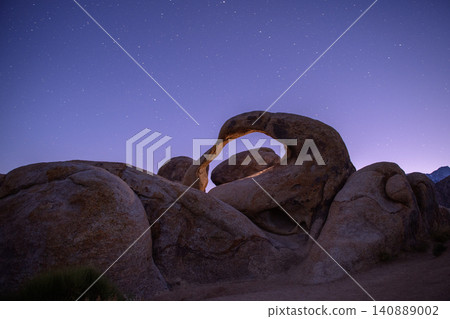 Sierra nevada california natural arch rock formation under starry night sky with granite boulder in quiet desert landscape Sierra nevada california natural arch rock formation under starry night sky with granite boulder in quiet desert landscape 140889002