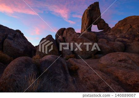 Sierra nevada california arch rock boulder desert landscape at colorful sunset sky over rugged granite formation in natural park Sierra nevada california arch rock boulder desert landscape at colorful sunset sky over rugged granite formation in natural park 140889007