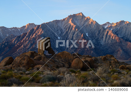 Sierra nevada california mountain desert rock formation at sunrise glow over rugged peak and arid shrub landscape Sierra nevada california mountain desert rock formation at sunrise glow over rugged peak and arid shrub landscape 140889008