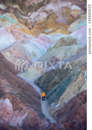 Sierra nevada california colorful hill hiker trail desert canyon landscape with solitary figure walking through pastel mineral terrain Sierra nevada california colorful hill hiker trail desert canyon landscape with solitary figure walking through pastel mineral terrain 140889020