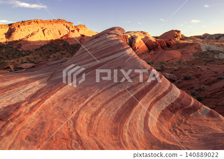 Sierra nevada california sandstone desert canyon striped rock formation at sunset with orange ridge and arid landscape texture Sierra nevada california sandstone desert canyon striped rock formation at sunset with orange ridge and arid landscape texture 140889022