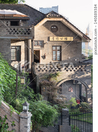 Nestled at No. 5 Longmenhao Old Street, Houzhen Mansion honors Chongqing Republic-era heritage. The estate fuses Western and traditional Chinese architecture. Weathered grey brickwork, grand arches, Nestled at No. 5 Longmenhao Old Street, Houzhen Mansion honors Chongqing Republic-era heritage. The estate fuses Western and traditional Chinese architecture. Weathered grey brickwork, grand arches, 140889384