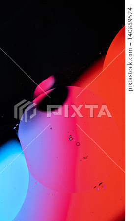 Oil drops creating an abstract pattern with gradients of red, blue, and purple color Oil drops creating an abstract pattern with gradients of red, blue, and purple color 140889524