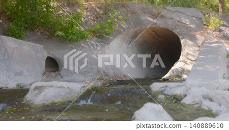 Large round sewage outlet contributing to coastal pollution 140889610