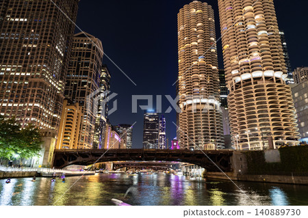 Chicago architecture of skyscraper. City night illuminated building. Skyscraper cityscape. Night city of Chicago. Business city. Night cityscape of Chicago skyscraper building. Nighttime reflection 140889730