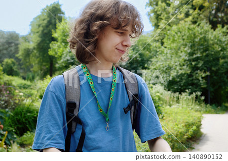 Young man wearing sunflower lanyard for hidden disability Young man wearing sunflower lanyard for hidden disability 140890152