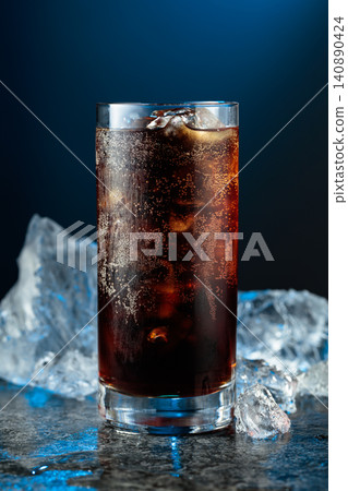 Cola with ice in misted glass on a black stone table. Cola with ice in misted glass on a black stone table. 140890424