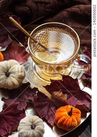 Warm tea with lemon and autumn leaves cozy hygge setting Warm tea with lemon and autumn leaves cozy hygge setting 140890602