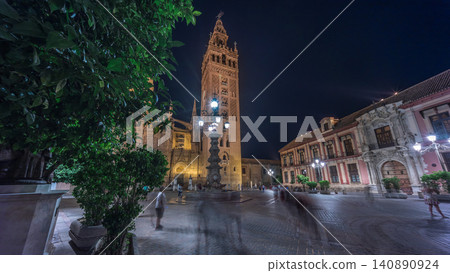 La Giralda and Seville Cathedral timelapse hyperlapse glowing under the night sky. La Giralda and Seville Cathedral timelapse hyperlapse glowing under the night sky. 140890924